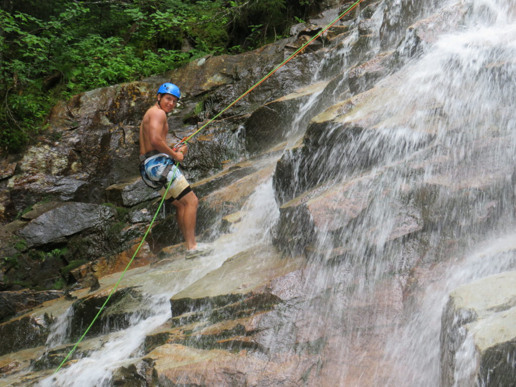 Repelling down a waterfall in Franconia Notch area